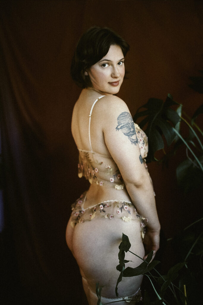 Milwaukee Companion Ivy Maxwell wearing lace lingerie, looking over her shoulder, her curvy bottom visible and teasing you